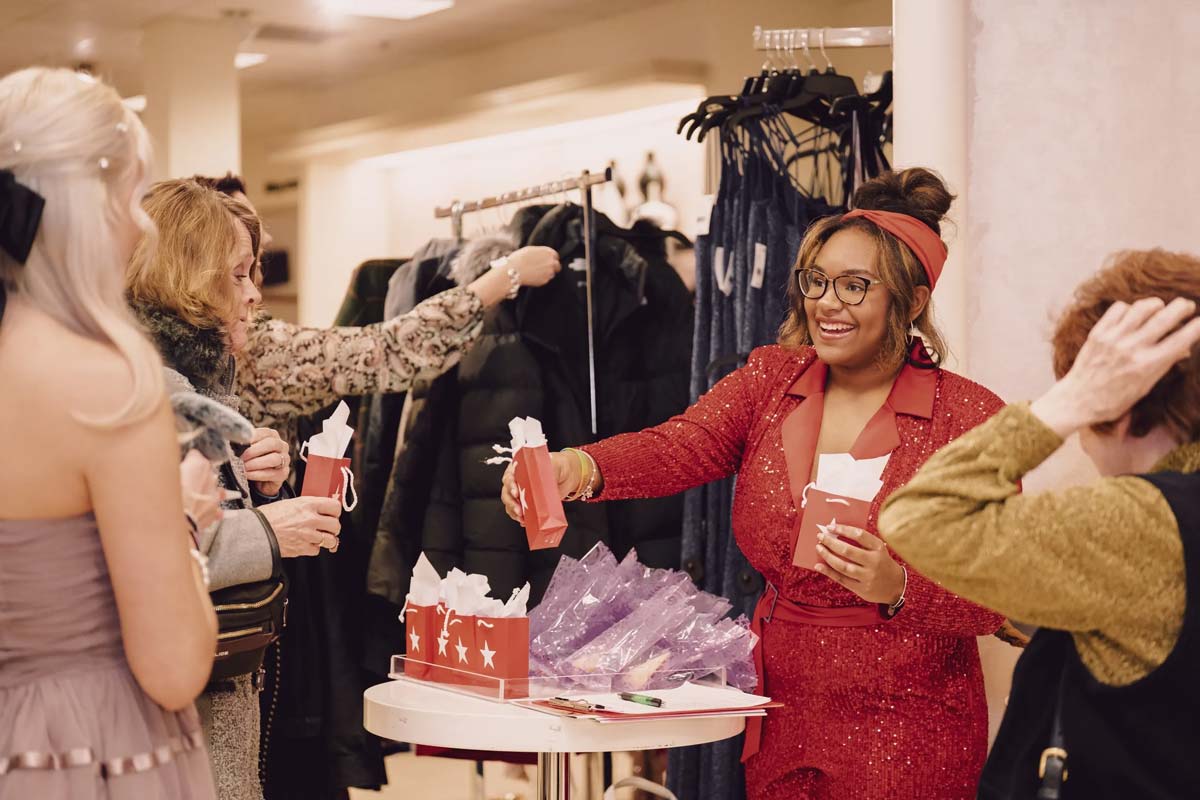Members handing out gift bags